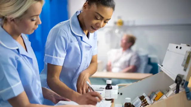 Nurses dispensing medicine in a hospital ward