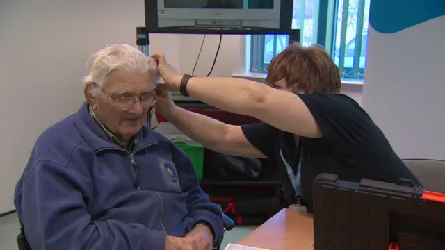 Hearing aid being fitted