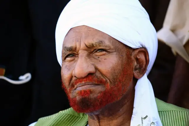 Sudanese opposition leader and ex-prime minister Sadiq al-Mahdi, whose civilian government was overthrown in a 1989 coup that brought President Omar al-Bashir to power, attends a gathering by supporters in Omdurman on January 26, 2017 upon his return to the country