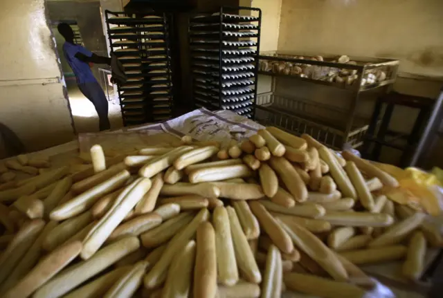 A pile of baguettes in a bakery