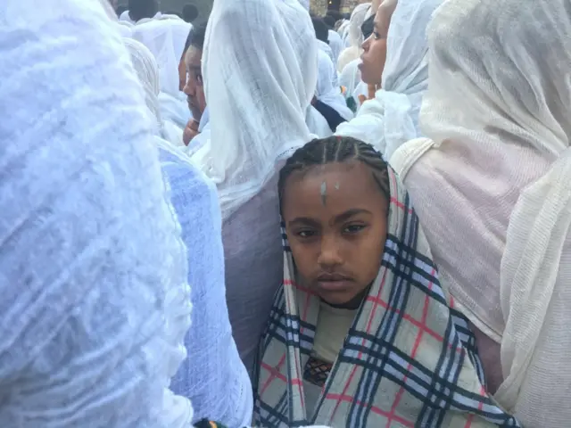 Timkat festival - a young girl looks at the camera