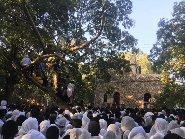 Timkat festival - worshippers assemble next to a church