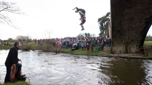 Men jump into the river Dove