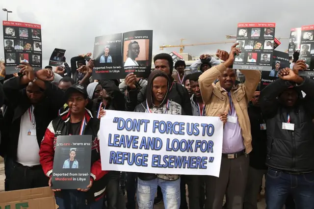 African asylum seekers, mostly from Eritrea, who entered Israel illegally during the past years, hold placards showing migrants who they say were killed after being deported to their country, during a protest against Israel's deportation policy in front of the Supreme Court in Jerusalem on January 26, 2017