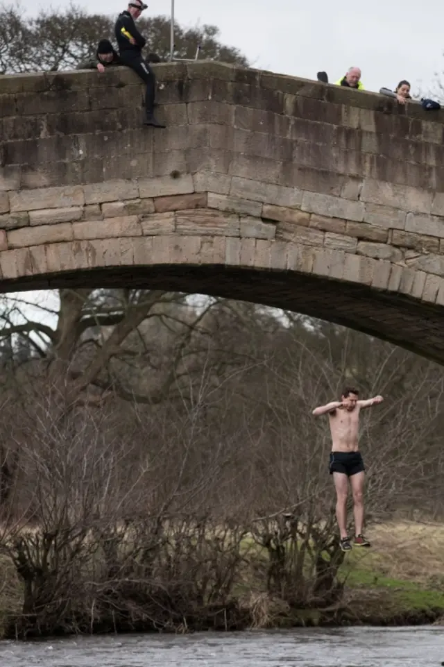 Man jumps into a river