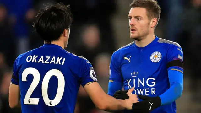 Shinji Okazaki shakes hands with Jamie Vardy before being substituted