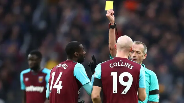 James Collins of West Ham United is shown a yellow card