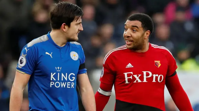 Troy Deeney of Watford talks to Leicester's Harry Maguire