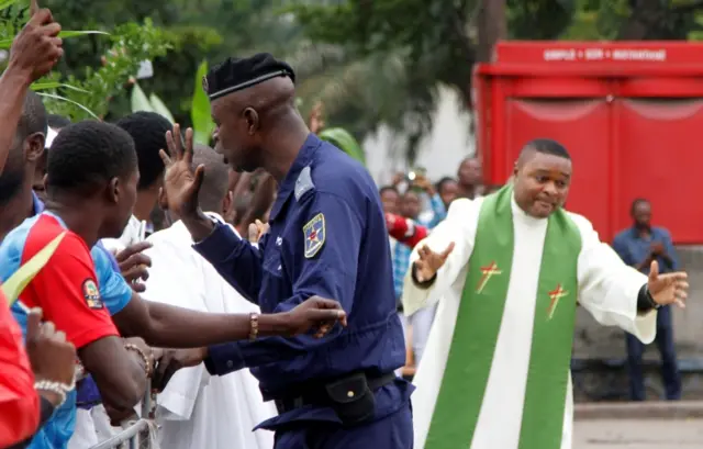 Riot policemen attempt to block a Catholic priest and demonstrators during a protest against President Joseph Kabila, organized by the Catholic church in Kinshasa, Democratic Republic of Congo January 21, 2018.