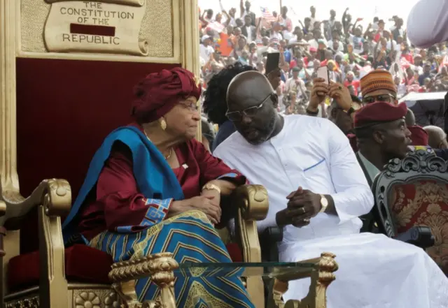 Liberia"s former President Ellen Johnson Sirleaf and the new President elect George Weah speak during his swearing-in ceremony at the Samuel Kanyon Doe Sports Complex in Monrovia, Liberia, January 22