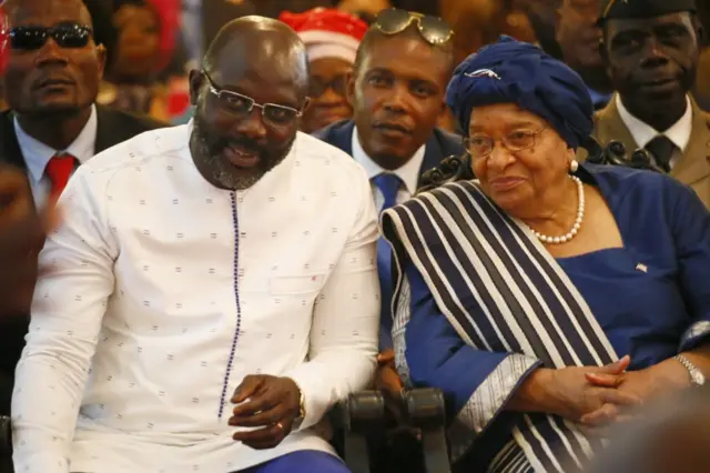 Liberia"s president elect, George Weah (L), outgoing President Ellen Johnson Sirleaf (R) attend an intercessory prayer service at the Cemtennial Memorial Pavilion in Monrovia, as part of events marking the official inauguration ceremony of president elect, George Weah, in Monrovia, Liberia