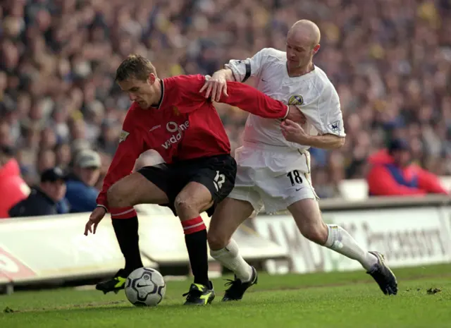 Phil Neville and Danny Mills challenge for the ball during their playing days