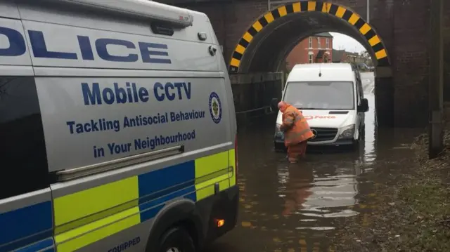 The van in flood water having a tow rope attached