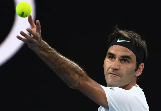 Roger Federer serves