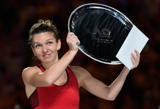 Simona Halep holds up the runners-up trophy