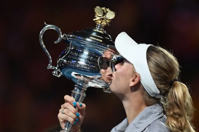 Caroline Wozniacki of Denmark kisses her trophy