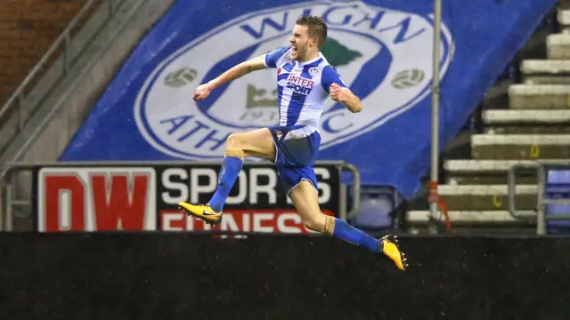 Elder of Wigan celebrates scoring against Bournemouth