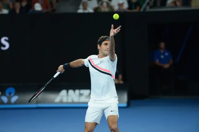 Roger Federer serves