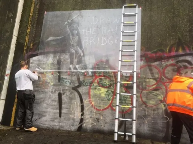 Sheet of plastic covers Banksy artwork