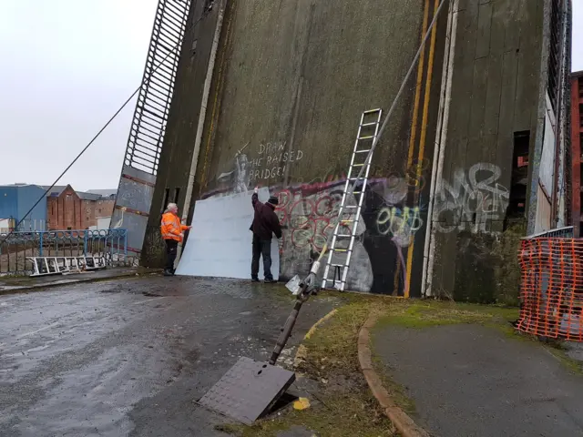 Contractors on site of Banksy mural