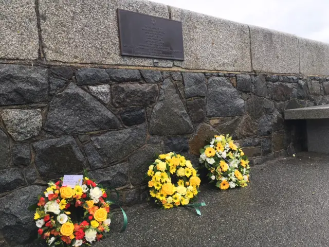 Wreathes at the plaque to three Jewish women deported from Guernsey