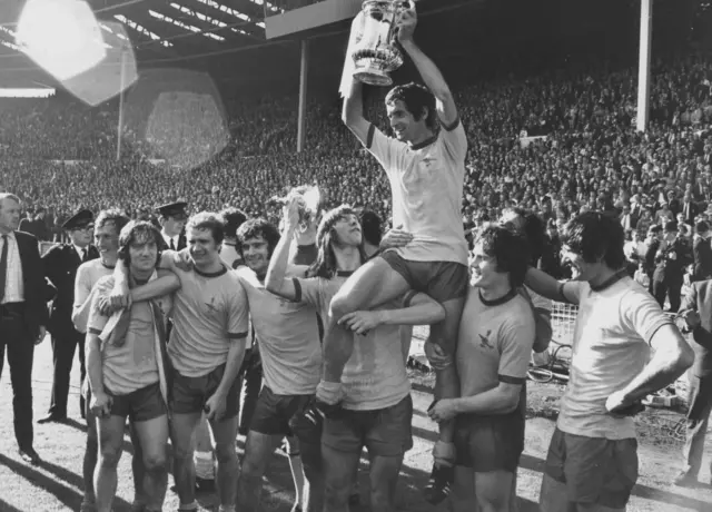 Arsenal captain Frank Mclintock holds aloft the FA Cup