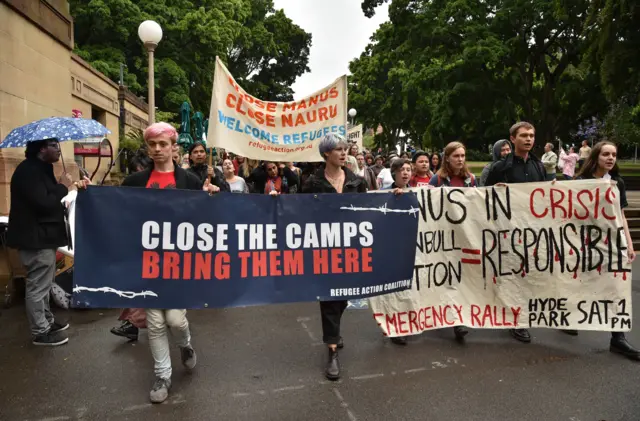 Protesters holding banners march in Sydney to urge the Australian government to end the refugee crisis on Manus Island on November 4, 2017