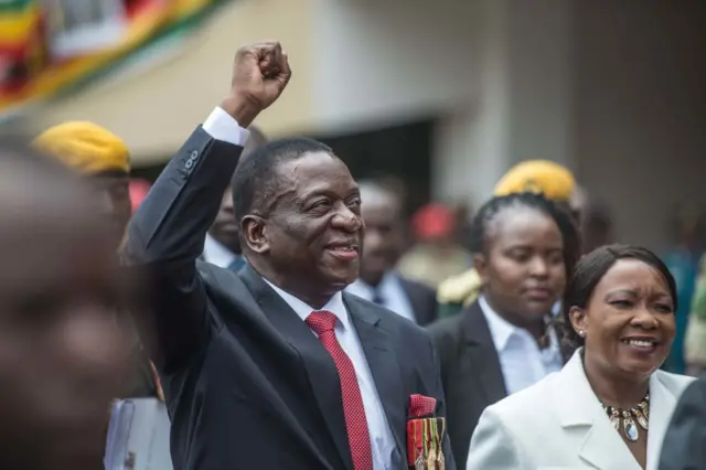 Zimbabwean newly sworn-in President Emmerson Mnangagwa flanked by his wife Auxilia gestures during the Inauguration ceremony at the National Sport Stadium in Harare, on November 24, 2017.