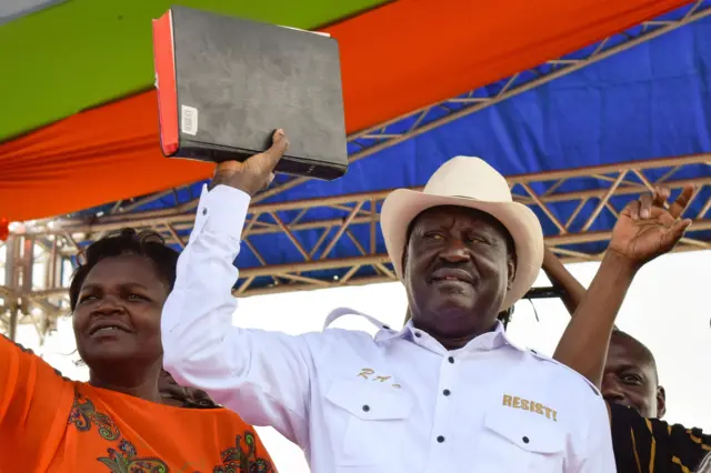 Kenyan opposition party National Super Alliance (NASA) leader, Raila Odinga holds a bible during a rally in Homa Bay on the shores of Lake Victoria, on January 27, 2018