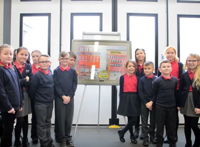 Children in front of artwork