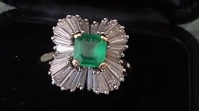 An emerald and diamond ring