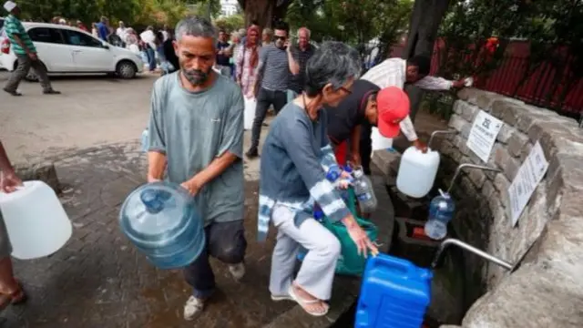 Residents collect water