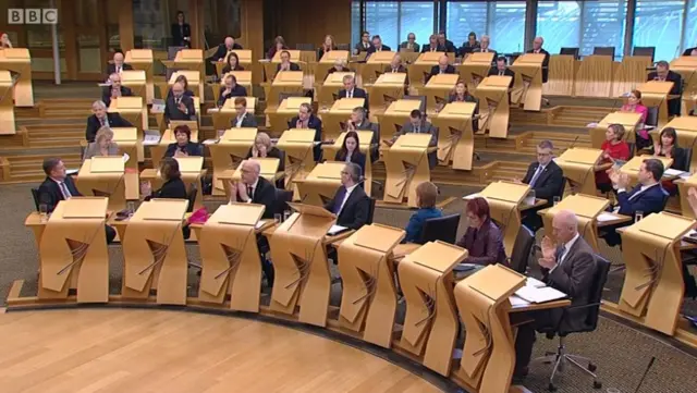 SNP benches applauding