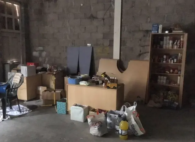 Food on shelves inside the derelict building.