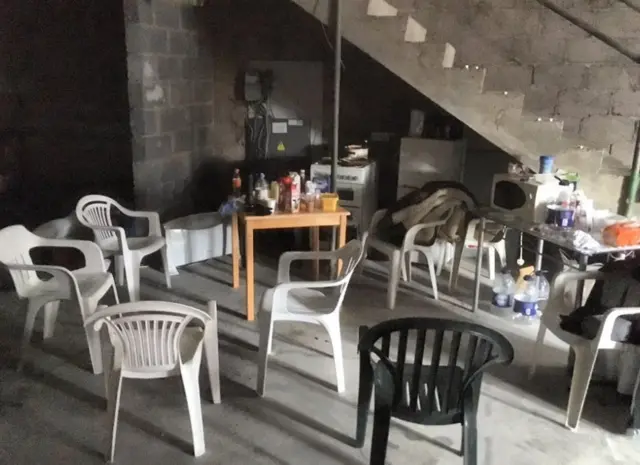 Chairs and tables inside the derelict building.