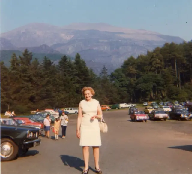 Edith on holiday with mountains in the background.