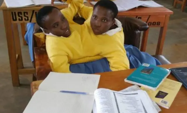 Maria and Consolata Mwakikuti in their school uniform