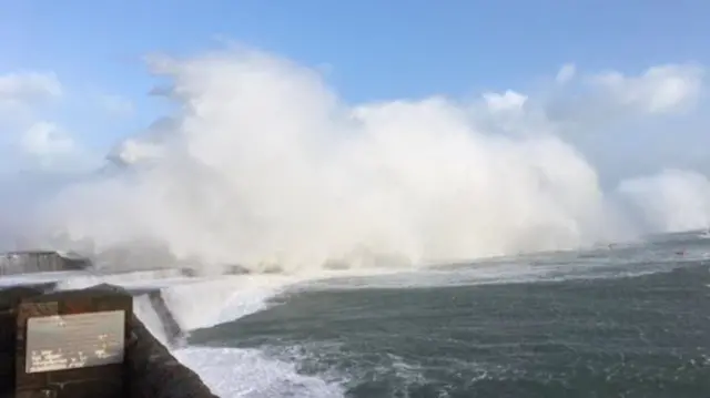 Waves crash over Alderney breakwater