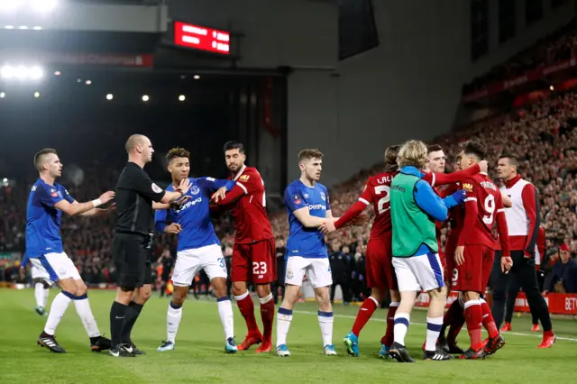 Liverpool and Everton players come together