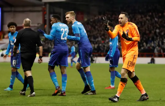 Arsenal players rush to the referee over the scoring of Nottingham's fourth goal