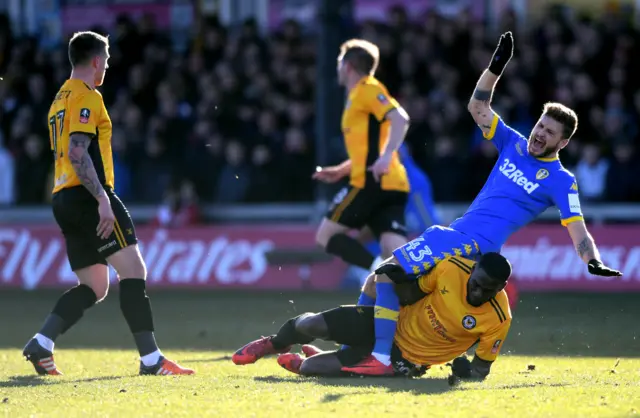 Frank Nouble of Newport County tackles Mateusz Klich of Leeds United