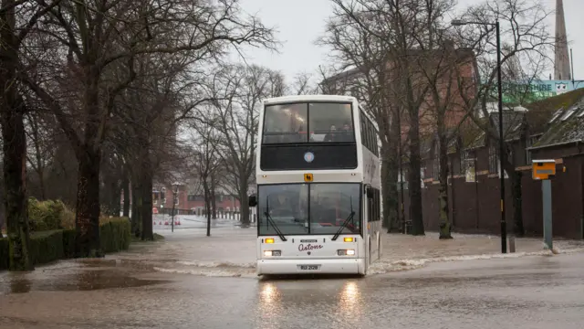 Bus drives through floodwater on New Road, on February 12, 2014