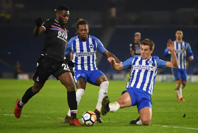 Timothy Fosu-Mensah of Crystal Palace is foiled by Brighton's Uwe Huenemeier and Gaetan Bong