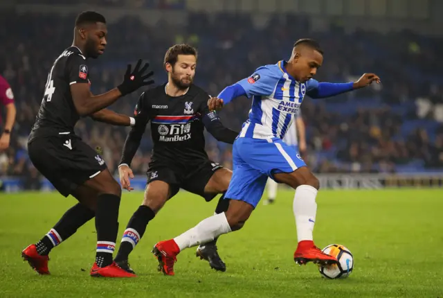 Jose Izquierdo of Brighton and Hove Albion evades Yohan Cabaye and Timothy Fosu-Mensah