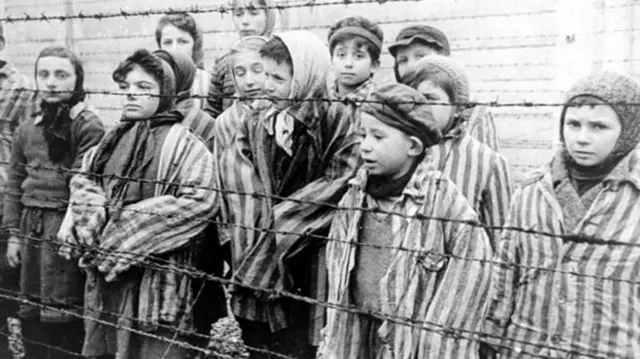 This photo shows children who survived the Holocaust. Read below to find out more about what it was and why it's important to remember it