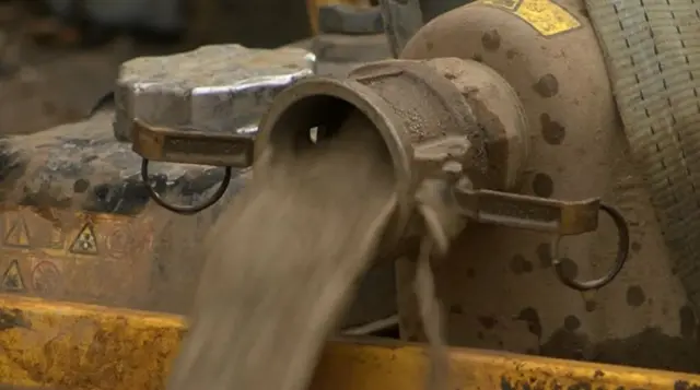 Water pouring out of a pump.