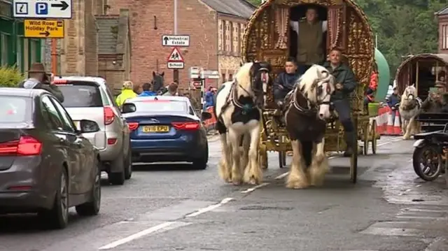 Travellers on a traditional horse and carriage.