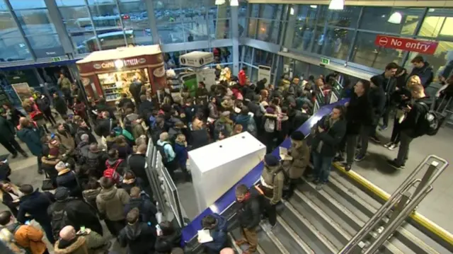 Rail passengers queuing in Bristol Parkway station