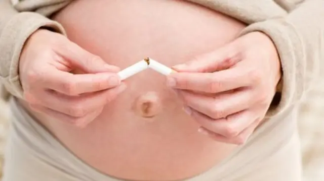 Anonymous picture of pregnant woman breaking cigarette