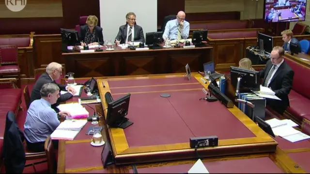 Wide shot of the inquiry